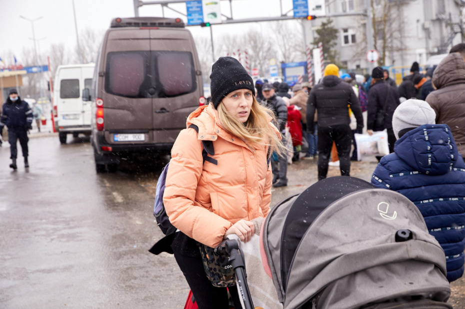 Woman pushing a pram.