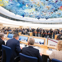 A view into the crowded Human Rights Council chambers where several journalist try to get the best spot for a picture of the speakers, among them the High Commissioner for Human Rights Volker Türk, Secretary-General Antonio Guterres, Human Rights Council President Vaclav Balek, General Assembly President Csaba Kőrösi, and UNOG Director-General Tatiana Valovaya (all seen from behind).