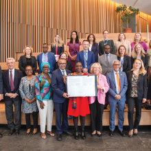 A group of UN Geneva senior managers are gathering for a group photo. 