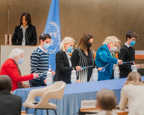 Guests light six candles at the 2022 Holocaust Remembrance Day ceremony at the Palais des Nations