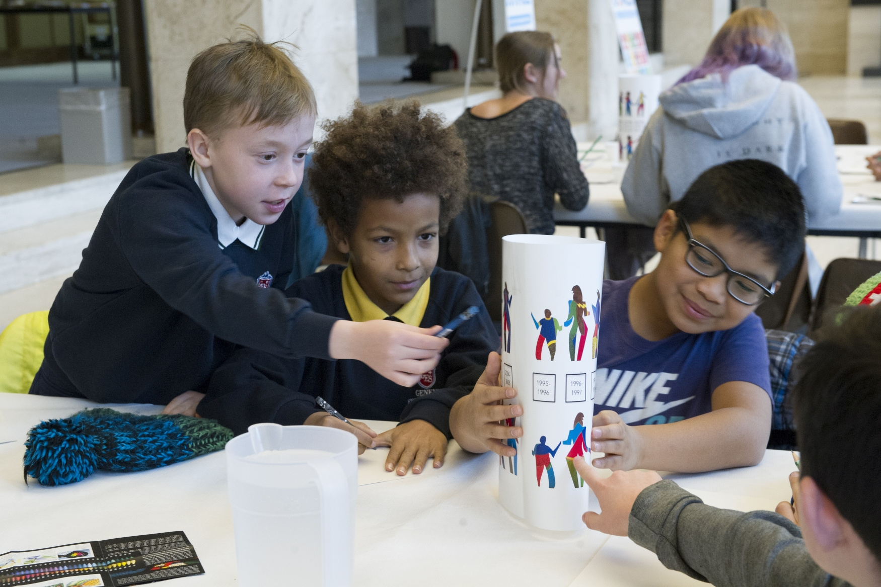 Three children crafting at a UN event.