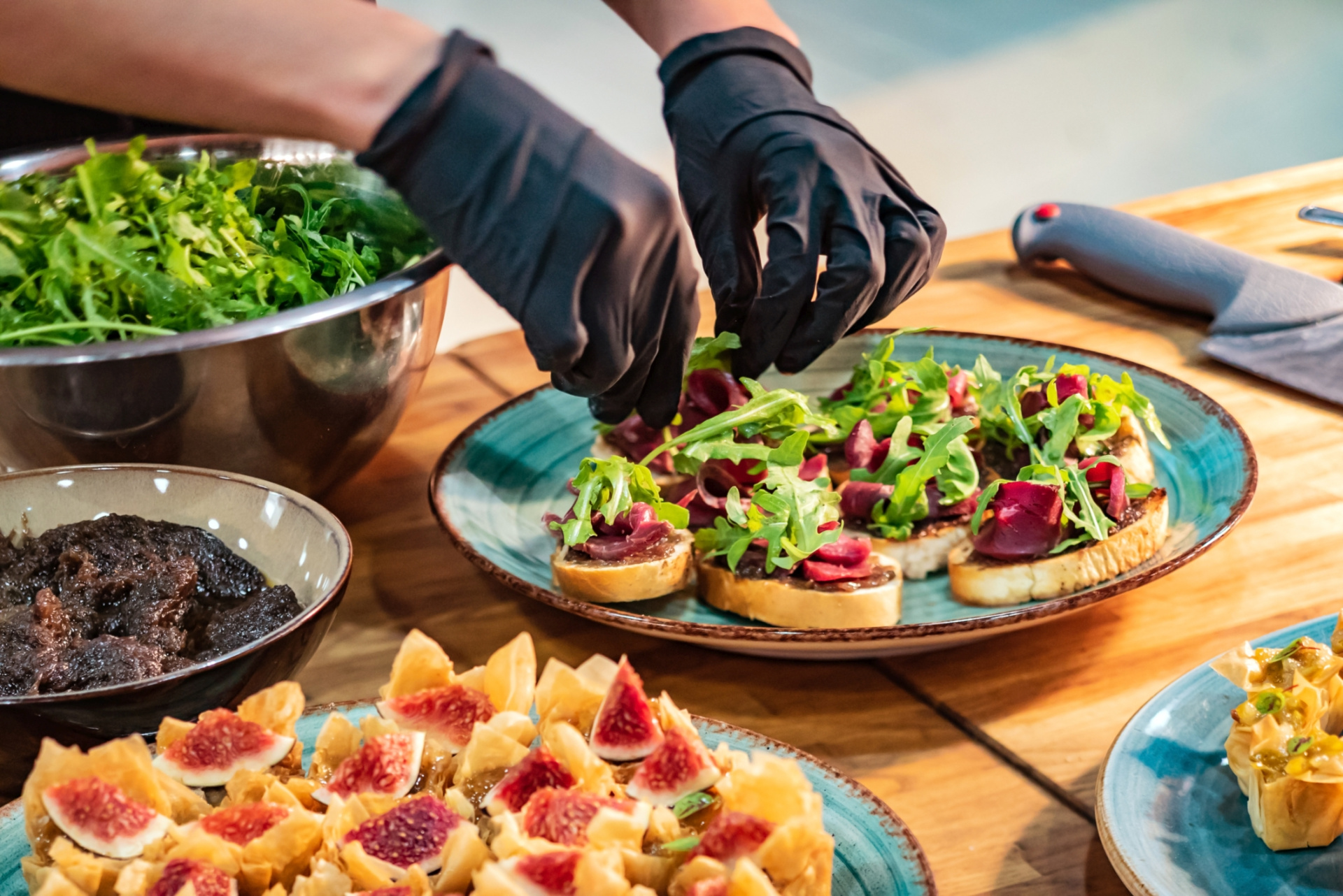 A food plate is prepared by a person wearing gloves.