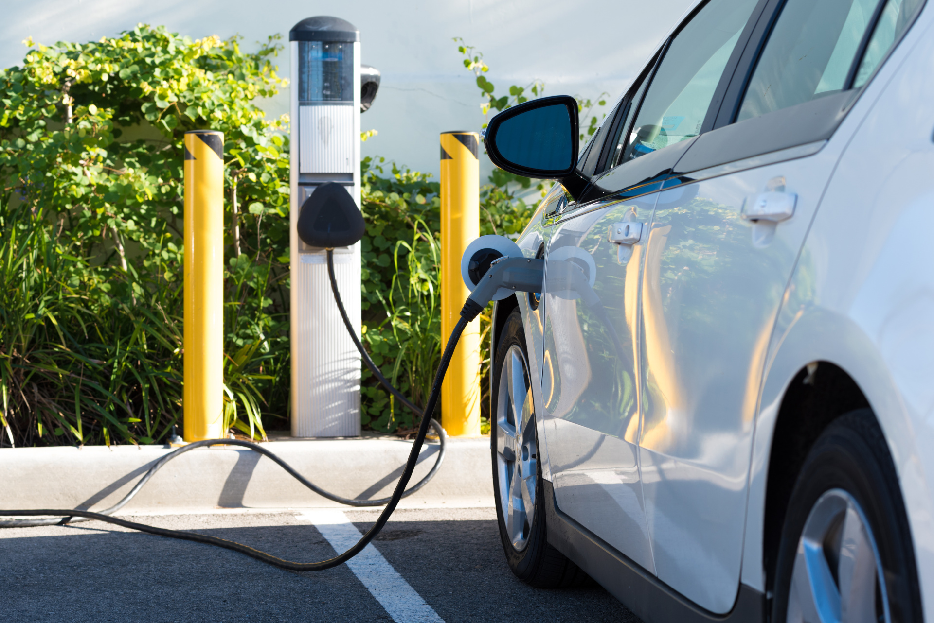 An electric car is connected to a charging station. 