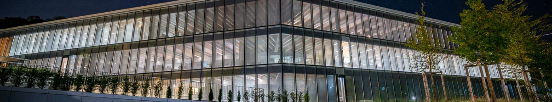 The newly-constructed and illuminated H Building is seen from outside at night.