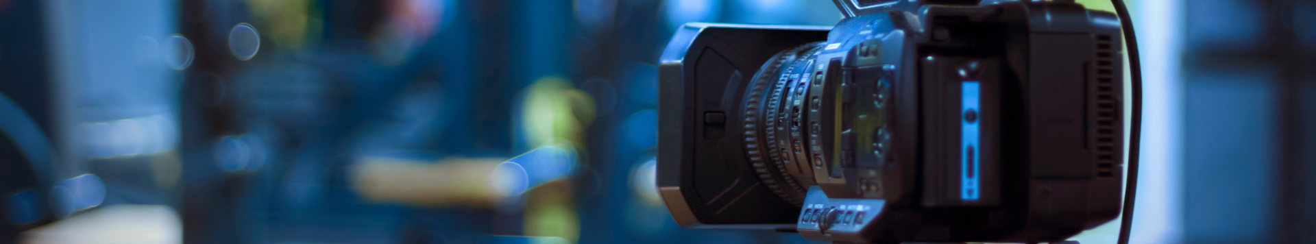 A video camera standing inside a dark room. 